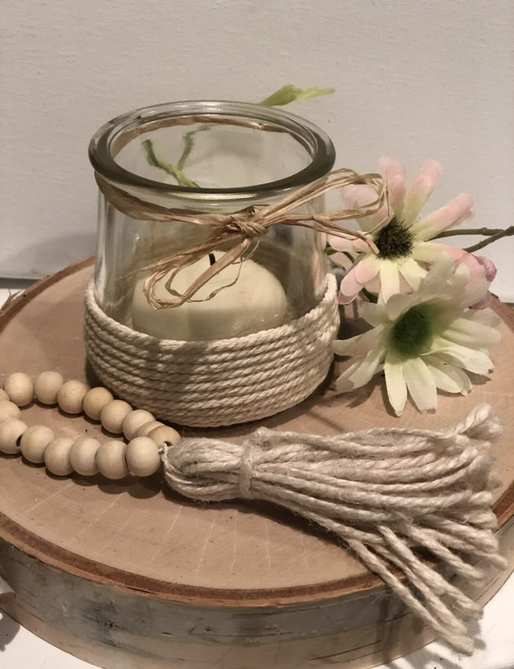 a candle and some beads on a table