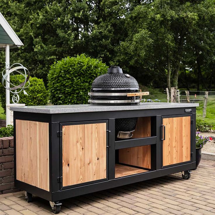 an outdoor bbq grill with wooden cabinets on wheels