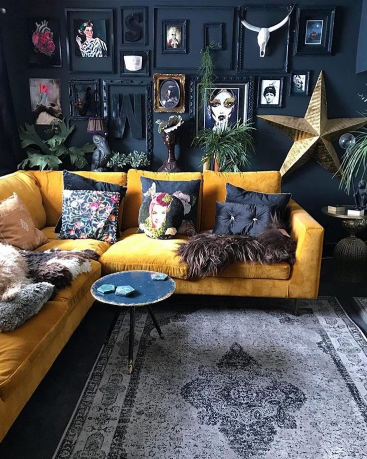 a living room filled with lots of furniture and pictures on the wall above it's couch