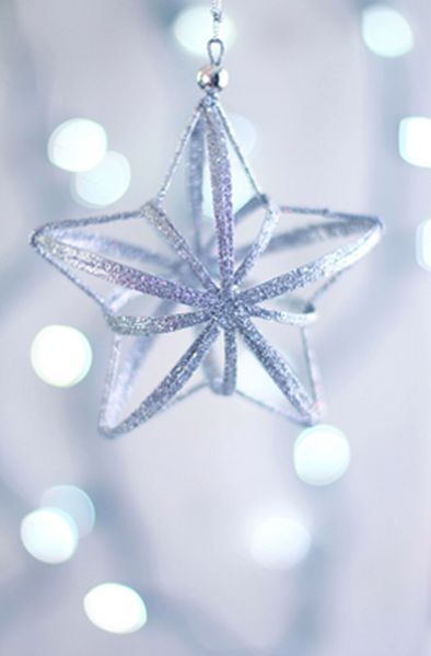 a silver star ornament hanging from a chain