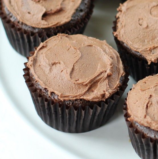 chocolate cupcakes with frosting on a white plate