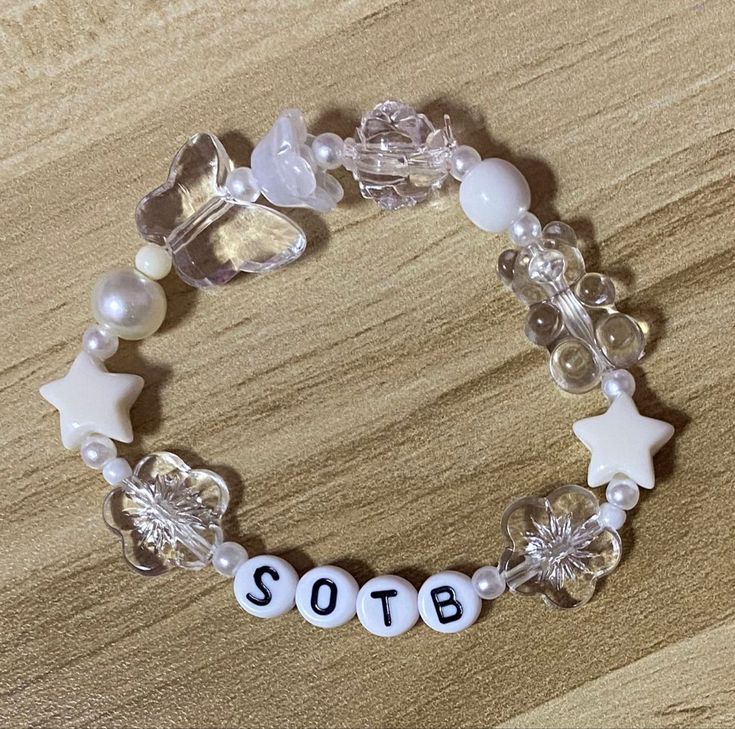 a beaded bracelet that says sota on the front, and white beads with star charms around it