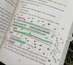 an open book with writing on the pages and some words written in green marker pens