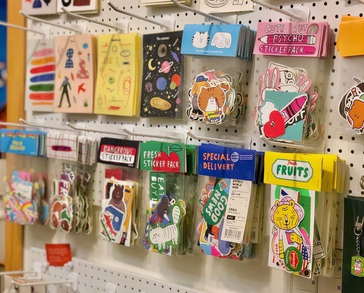 there are many different items on the wall in this store that is decorated with stickers and magnets