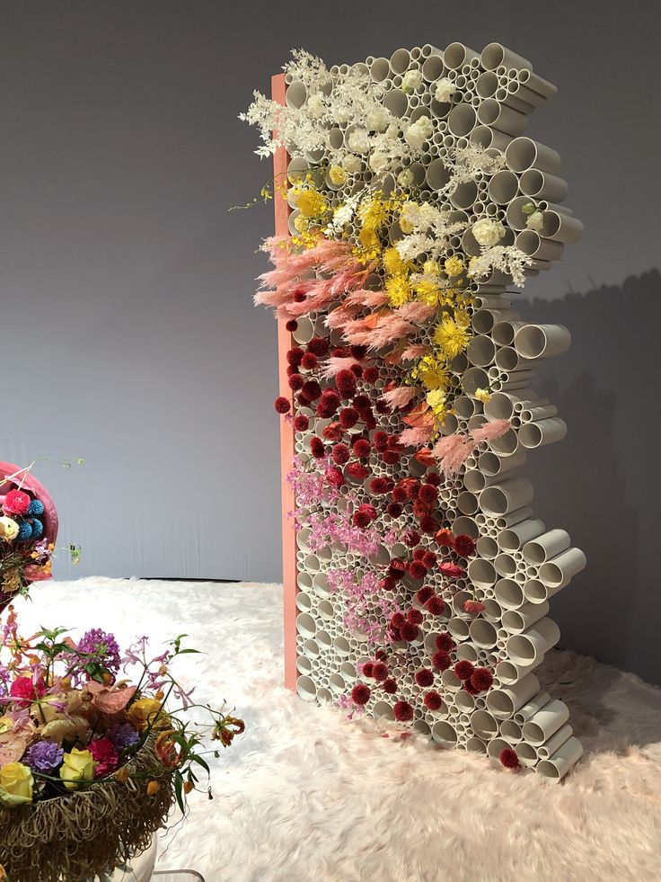 an arrangement of vases and flowers on display