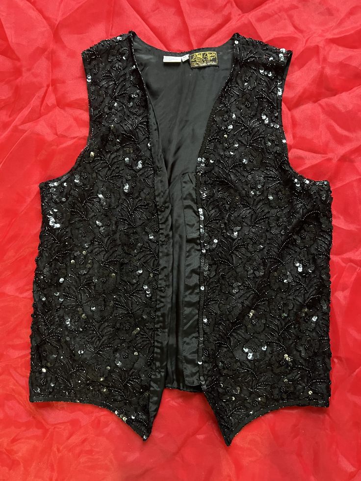 Beautiful beaded sequin vest, made in India. Fits Women's size M/L or Men's S, 100% rayon. Elegant Winter Party Vest, Winter Party Fitted Vest, Fitted Sleeveless Holiday Tops, Sequined Fitted Vest For Spring, Fitted Embellished Vest, Fitted Sequin Vest For Spring, Spring Beaded Fitted Tank Top, Spring Party Stretch Vest, Elegant Fitted Winter Tank Top