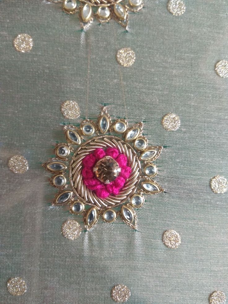 the fabric is covered with silver and pink beads