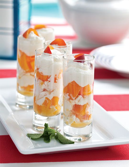 three glasses filled with dessert sitting on top of a white plate