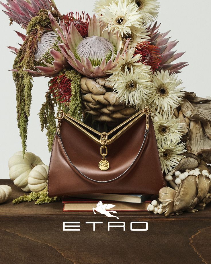 an image of a purse with flowers in it and the word etro written below