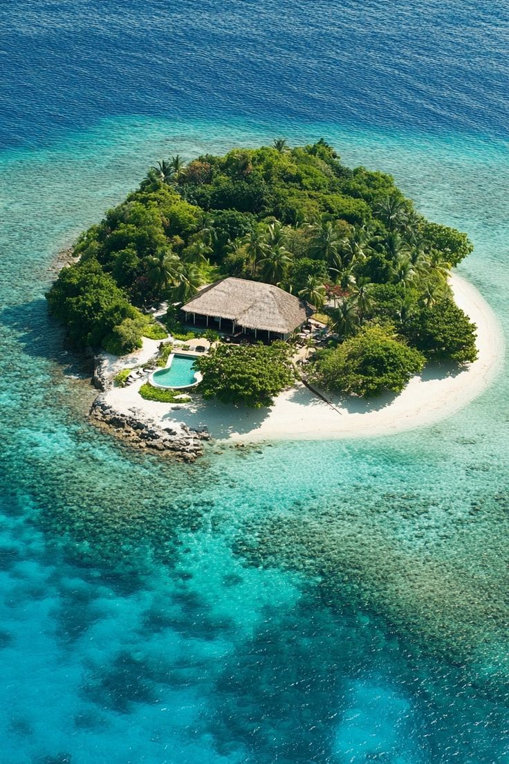 an island in the middle of the ocean with a hut on it's side