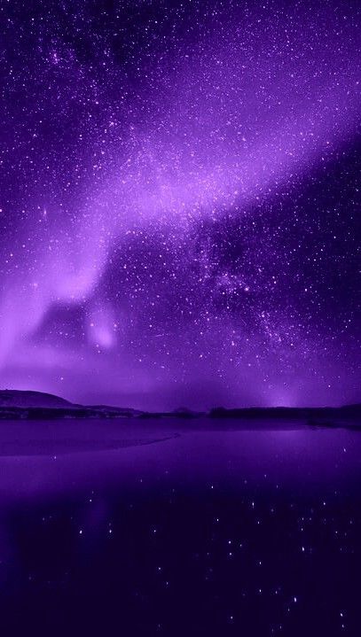 the night sky is filled with stars and purple hues as it reflects in water