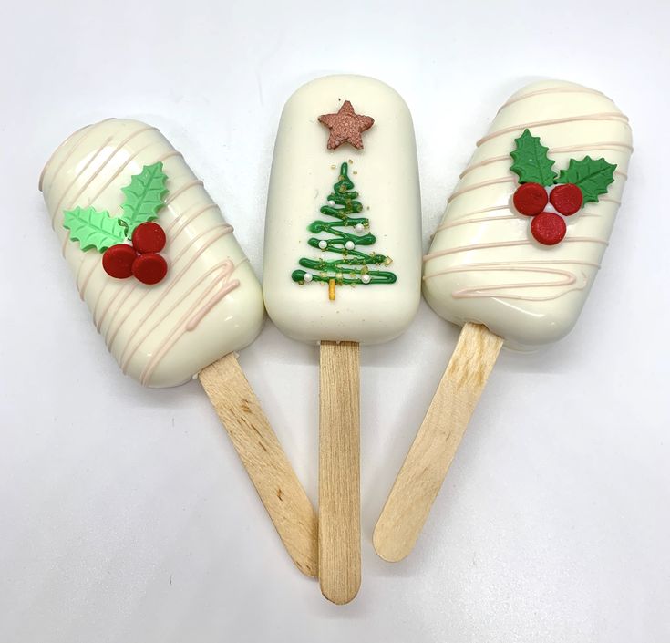 three pops decorated like christmas trees on wooden sticks