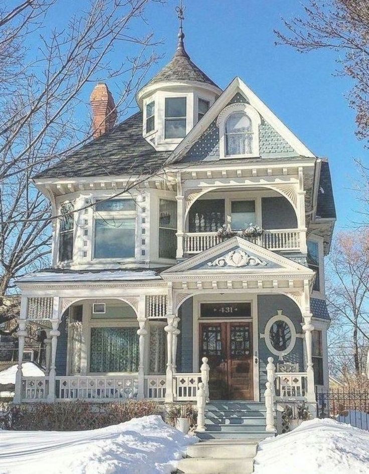 a large white house sitting on top of snow covered ground