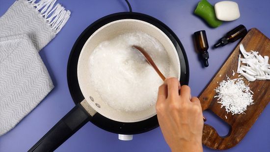 a person is cooking something in a pan on the table with other ingredients and utensils