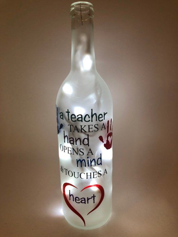 a glass bottle with writing on it and a heart shaped light up in the shape of a handprinted message