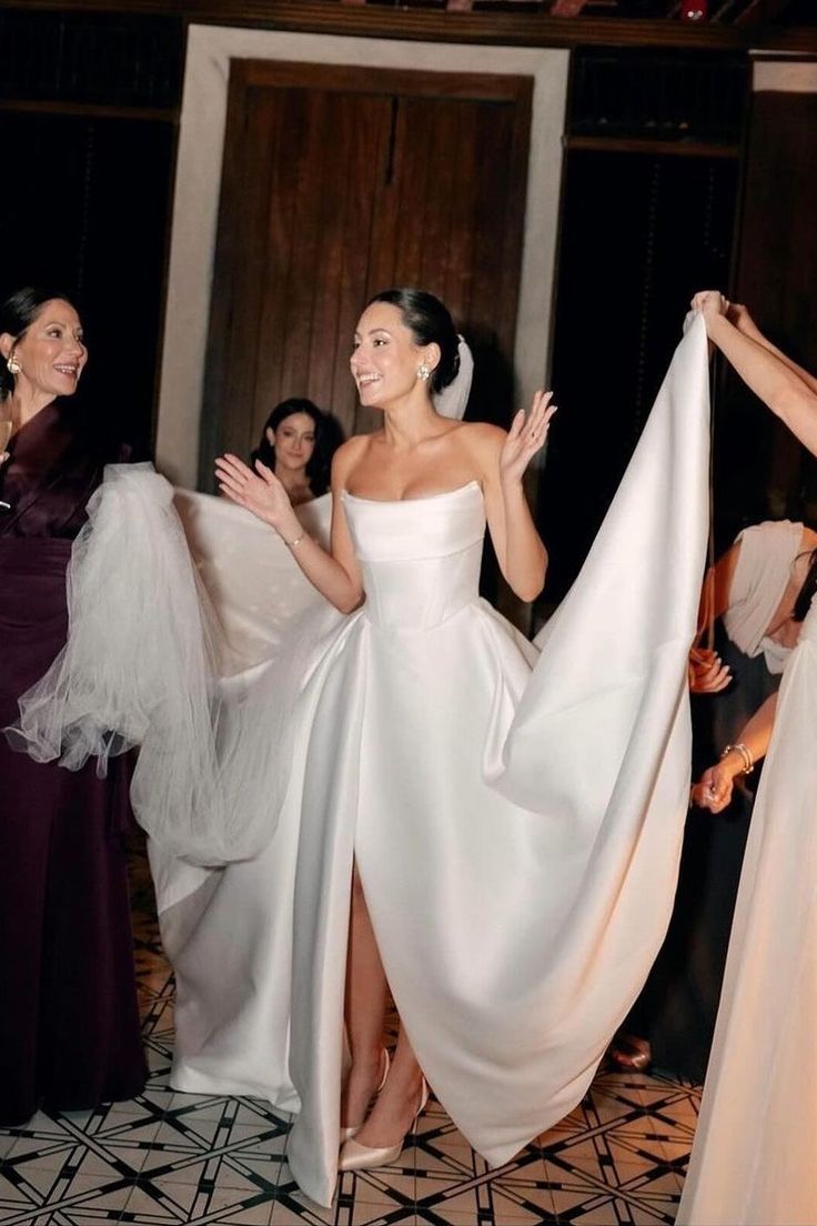 two women in white dresses standing next to each other