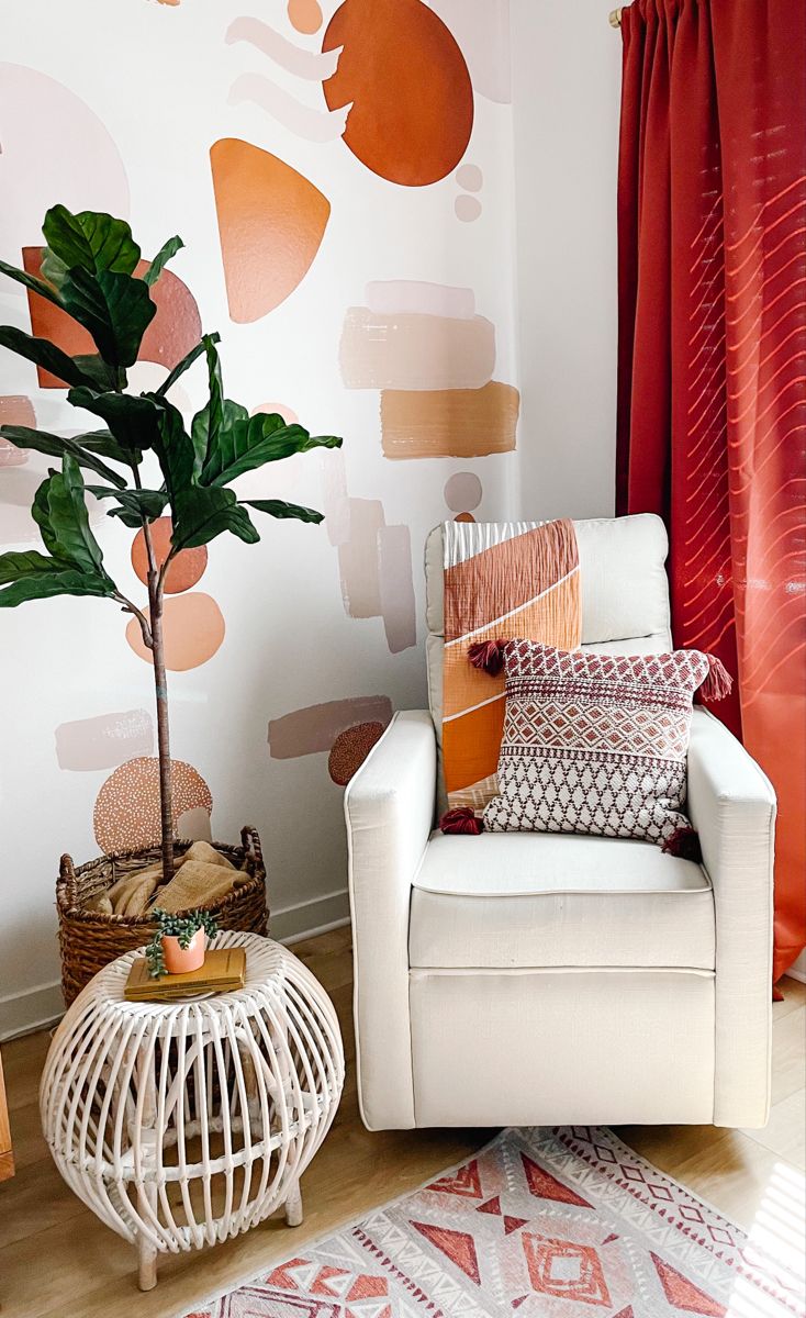 a white chair sitting next to a potted plant