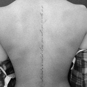 the back of a woman's neck with writing on her lower back and chest