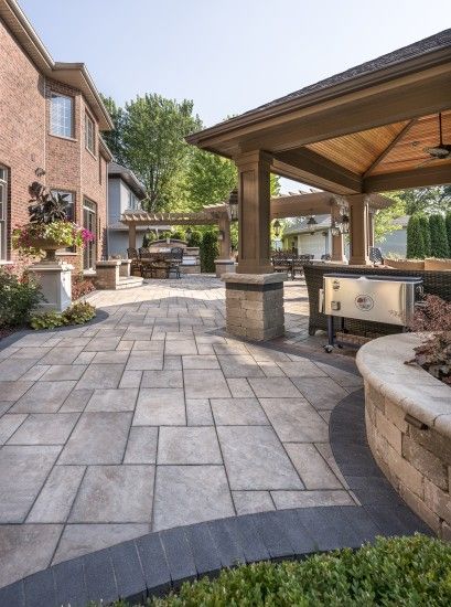 an outdoor patio with seating and grill area