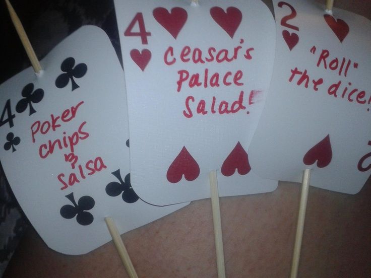 four playing cards with the words caesar's palace salad on them are held by toothpicks