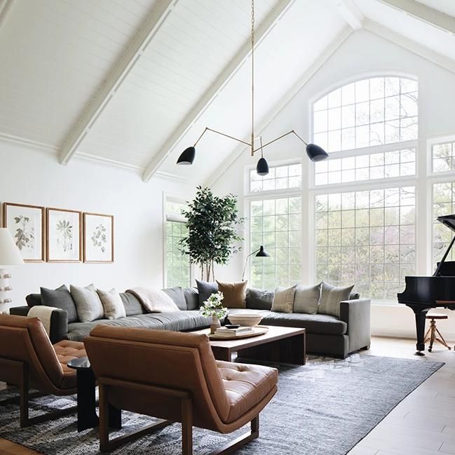 a living room filled with furniture and a grand piano