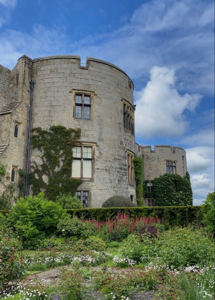 an old castle like building surrounded by greenery