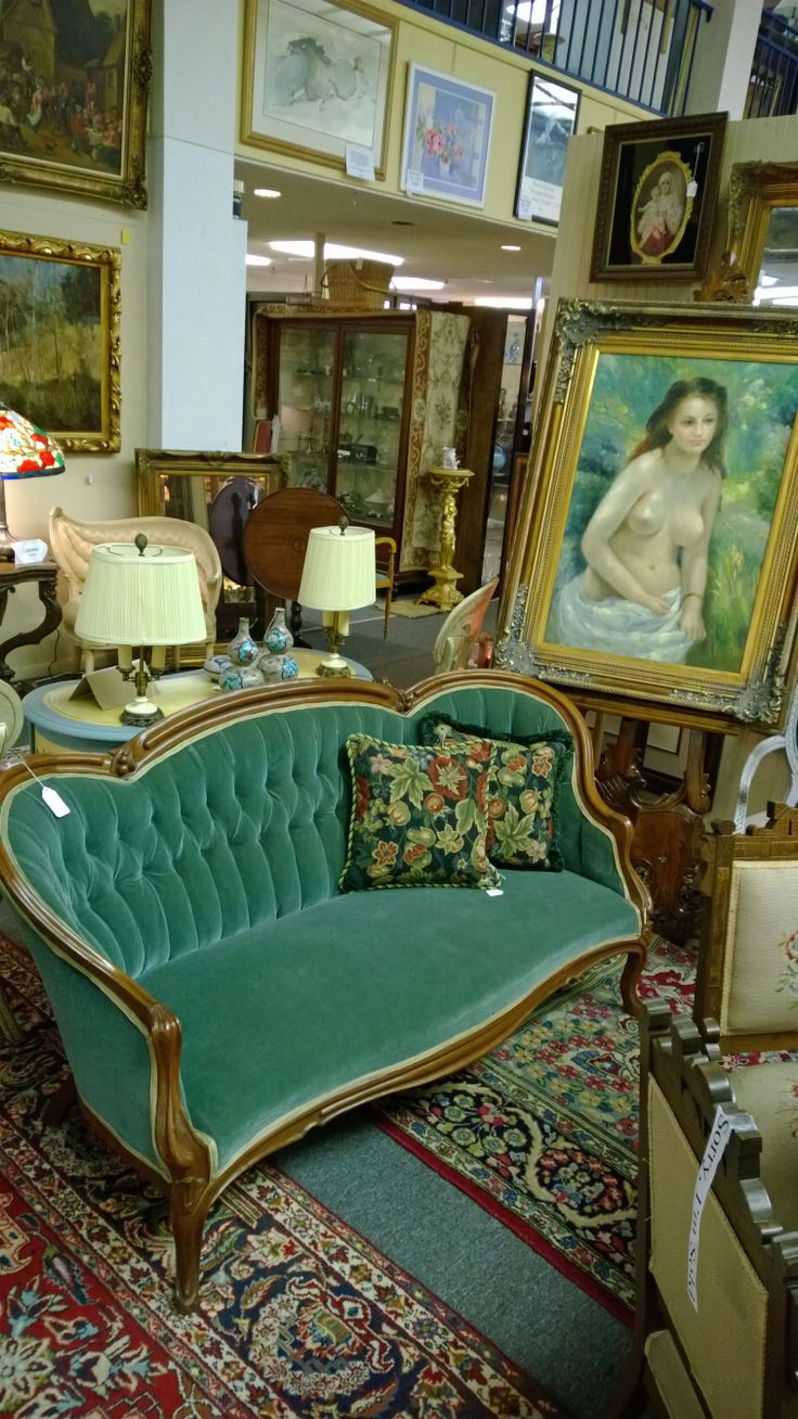 a living room filled with furniture and paintings