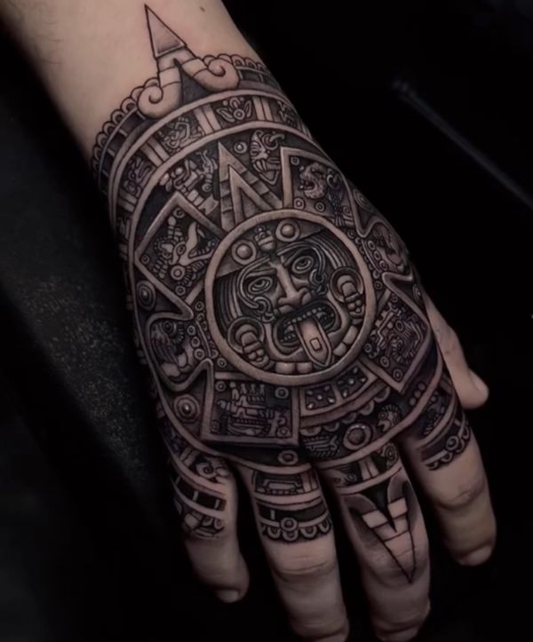 a hand with an intricate tattoo design on it