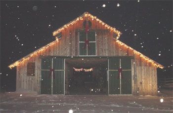 an old barn with christmas lights on it