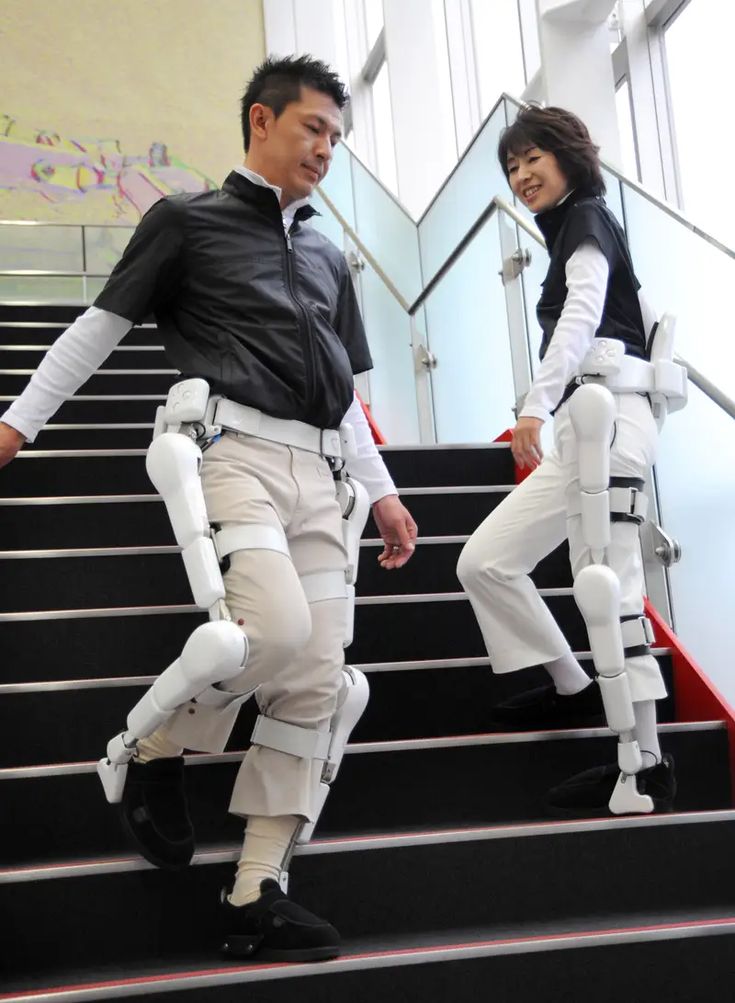 two people dressed in white standing on some stairs with their arms and legs spread out