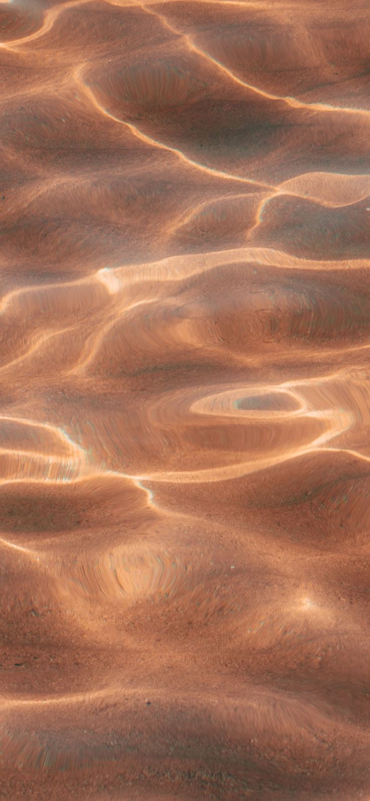 the water is brown and has ripples on it's surface, as seen from above