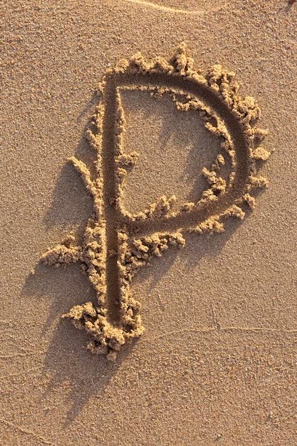 the letter p is drawn in the sand