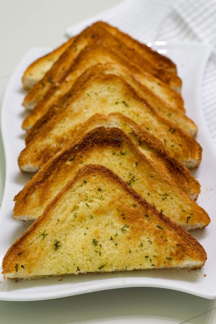 slices of garlic bread on a white plate