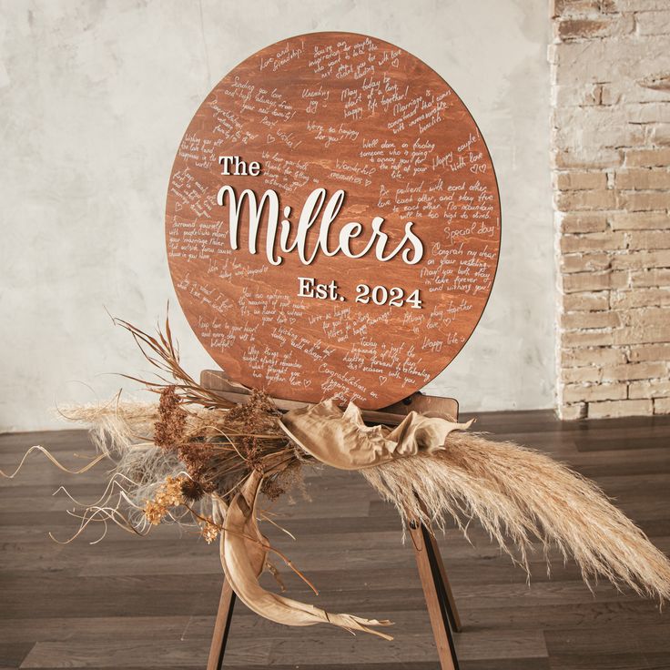 a wooden sign that says the millers on it with some dry grass in front of it