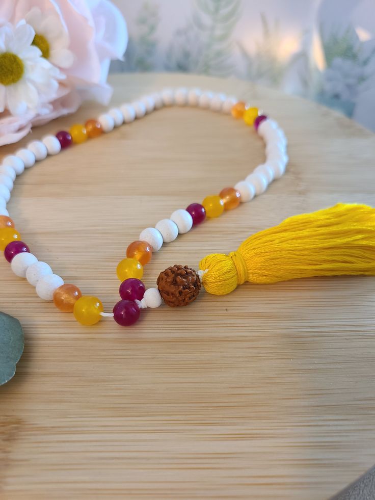 Whether as a meditation guide or as a beautiful, neutral and natural piece, this piece will make a great addition to your spiritual practice. This person's colors represent the 3 Chakras red/root, yellow/solar plexus and orange/sacral Japamala made with 54 Jade stone beads 8mm and wooden beads 8mm, rudraksha beads 10mm and cotton tassel 3mm. Dimensions: 11in long. >>What is in the package<< A beautiful Mala Prayer. The decoration around are not included. >>Colors may vary due to lighting and pho Spiritual Yellow Necklaces For Meditation, White 108 Beads Mala For Meditation, Multicolor Spiritual Necklace For Puja, White Mala With 8mm Beads For Rituals, Spiritual White Necklace For Rituals, Spiritual White Necklaces For Rituals, Handmade White Mala For Puja, Bohemian Adjustable Mala For Puja, White Handmade Mala For Puja