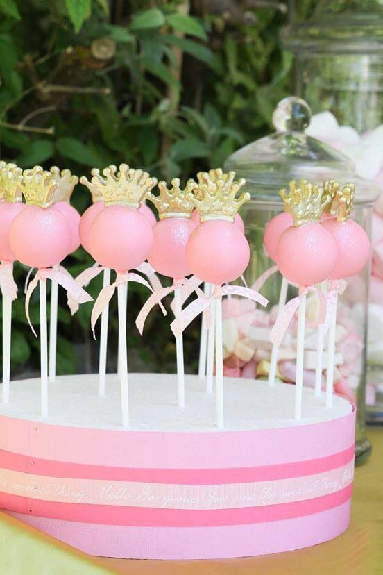 pink cake pops with gold crowns on top