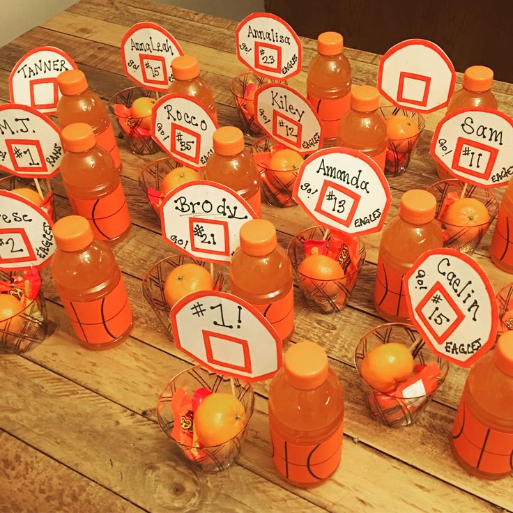 an arrangement of orange juice bottles with labels on them sitting on a wooden table top