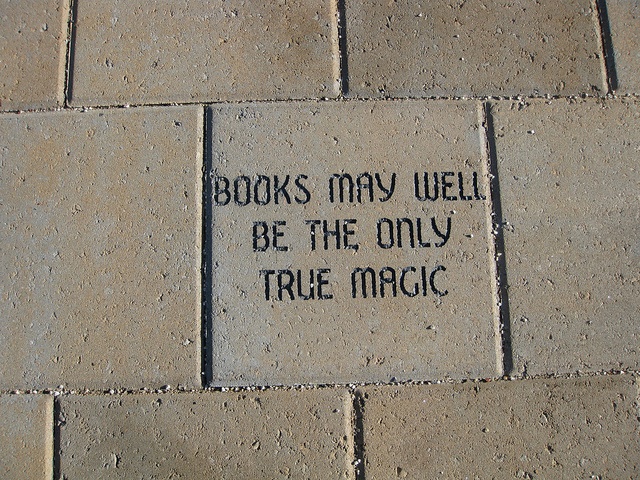 a brick sidewalk with writing on it that says books may well be the only true magic