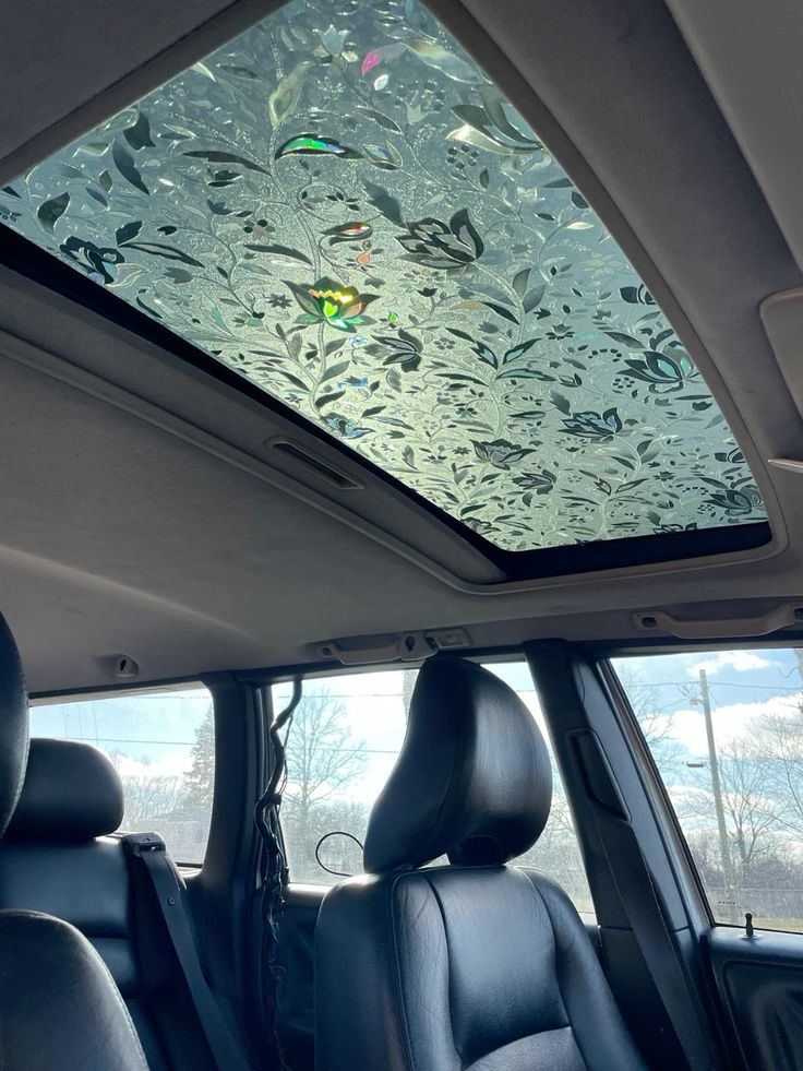 the interior of a car with frosted glass on the windshield and sunroofer