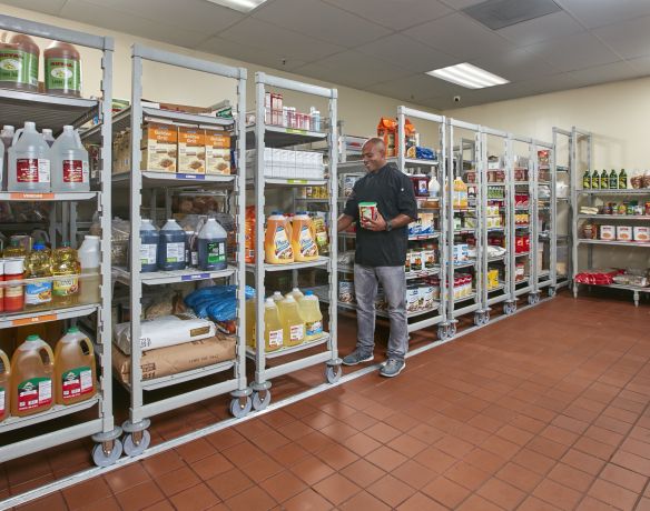 a man is standing in the aisle of a grocery store with shelves full of food