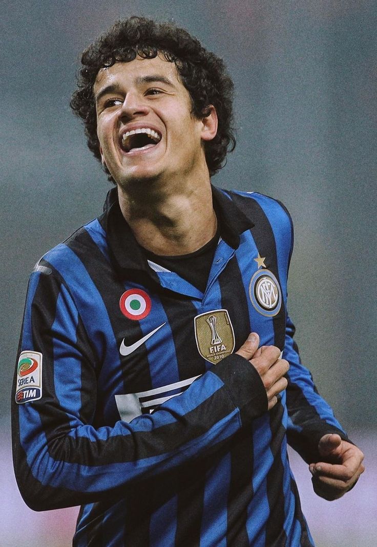 a young man is laughing while playing soccer