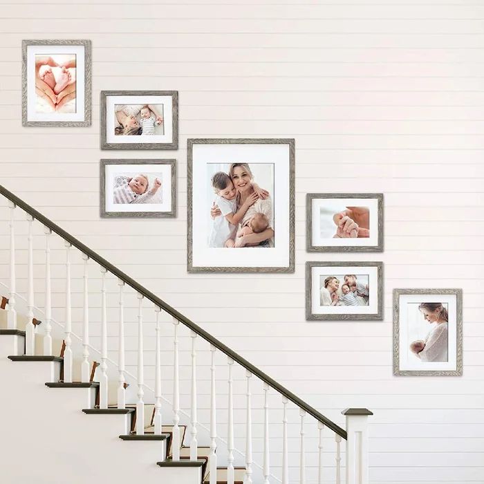 a stair case with pictures on the wall