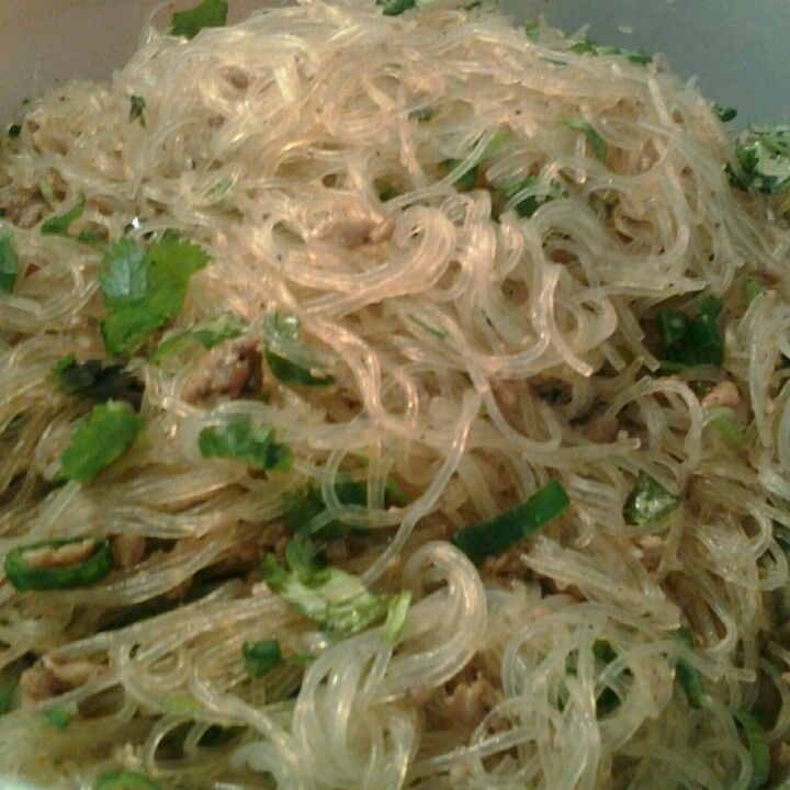 a white bowl filled with noodles and vegetables