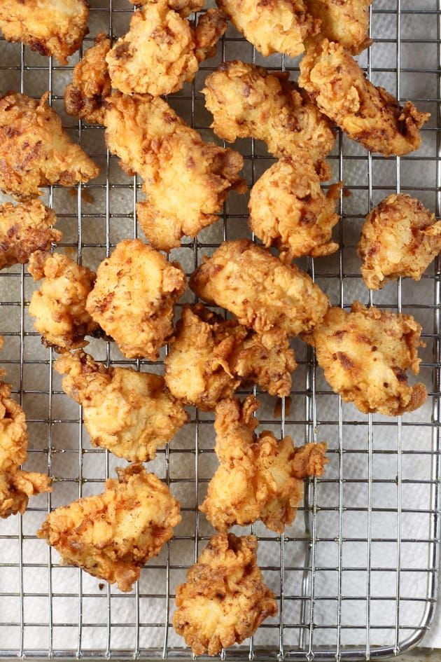 fried chicken on a cooling rack ready to be cooked