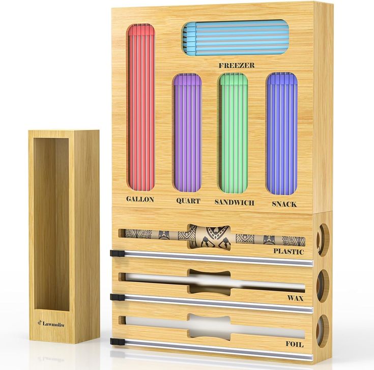 a wooden box with four different colored pencils in it next to a ruler and pen holder