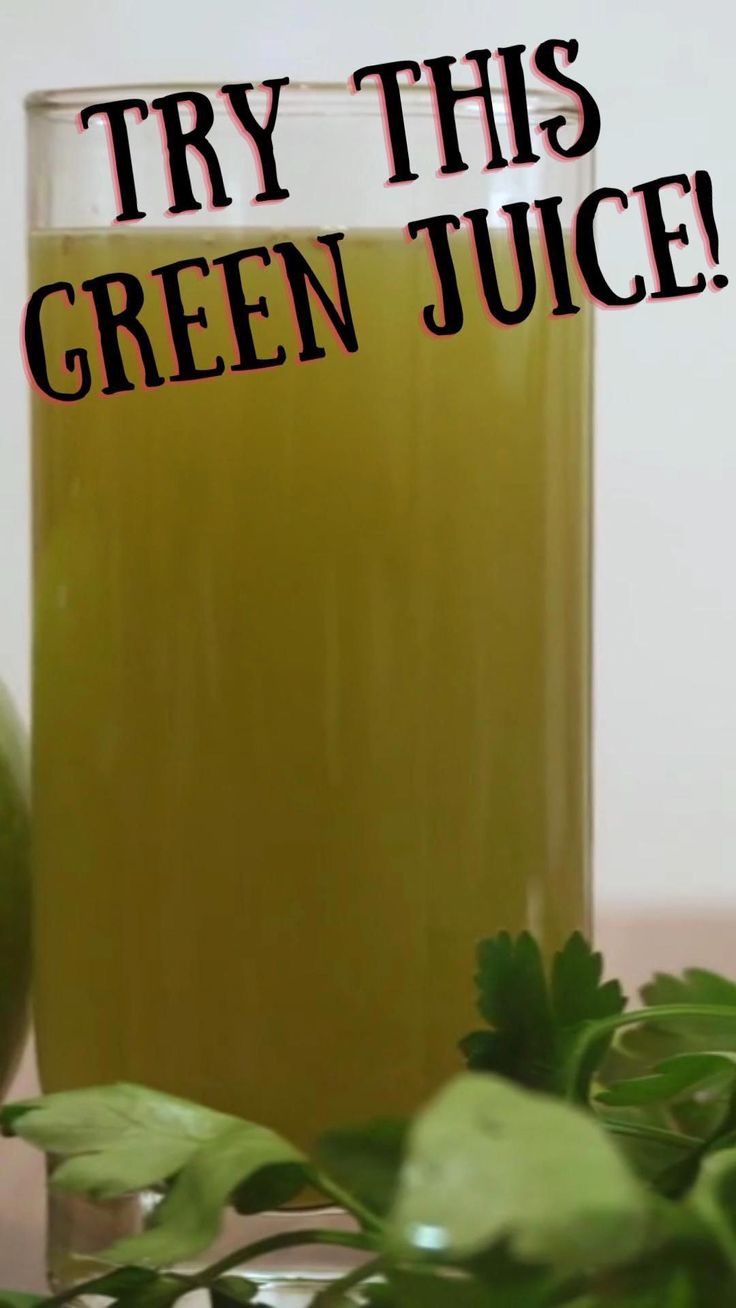 green juice in a glass next to leaves and an apple on a table with the words try this green juice