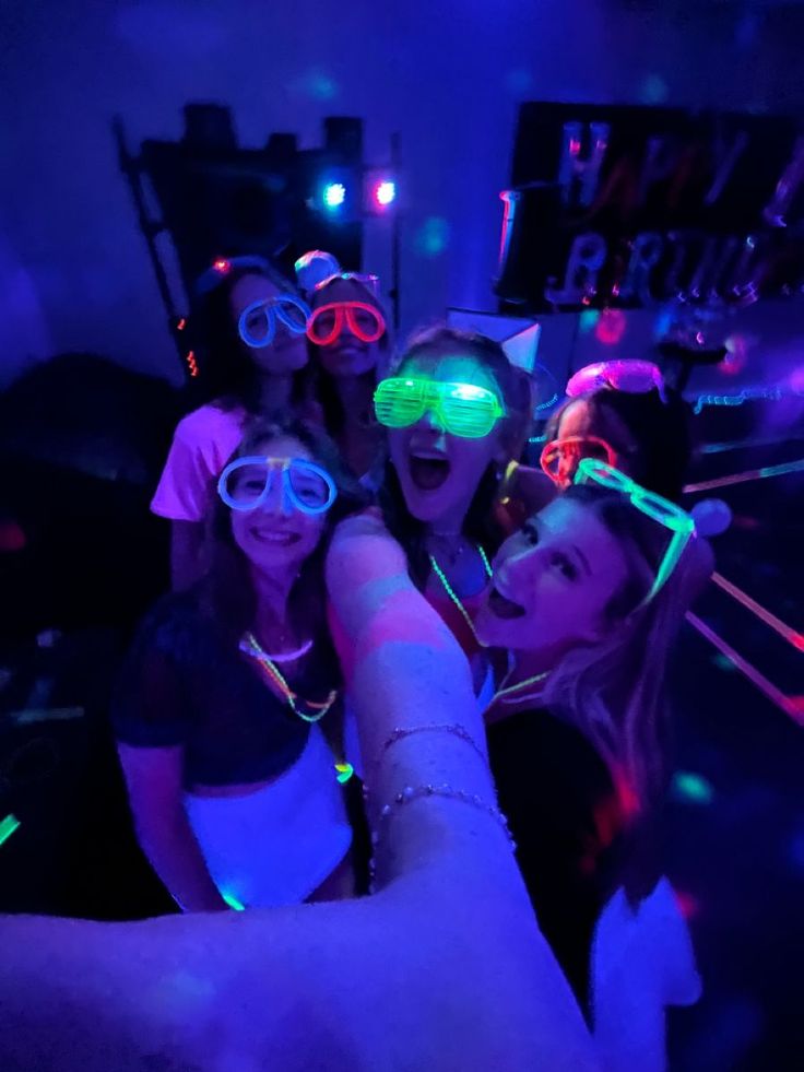 a group of young women wearing glowing goggles