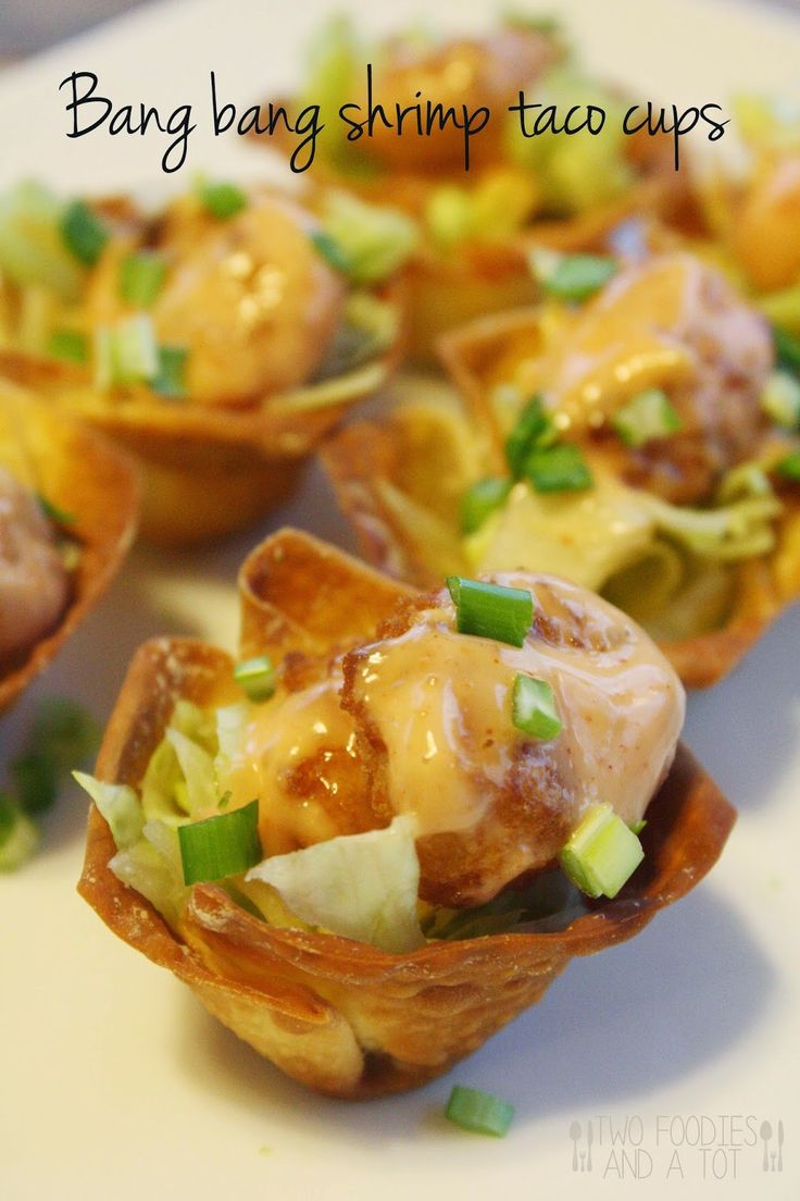 small cups filled with food sitting on top of a white plate and topped with green onions