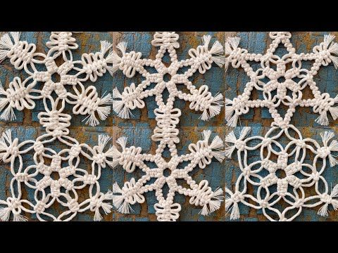 white crocheted snowflakes are hanging on the side of a brick wall