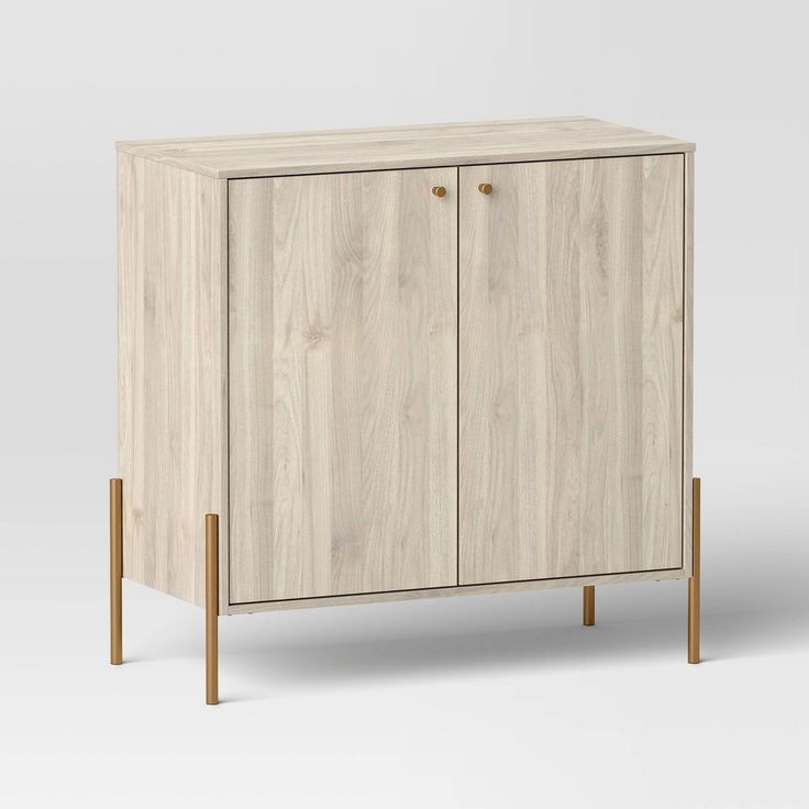 a white cabinet with two wooden legs